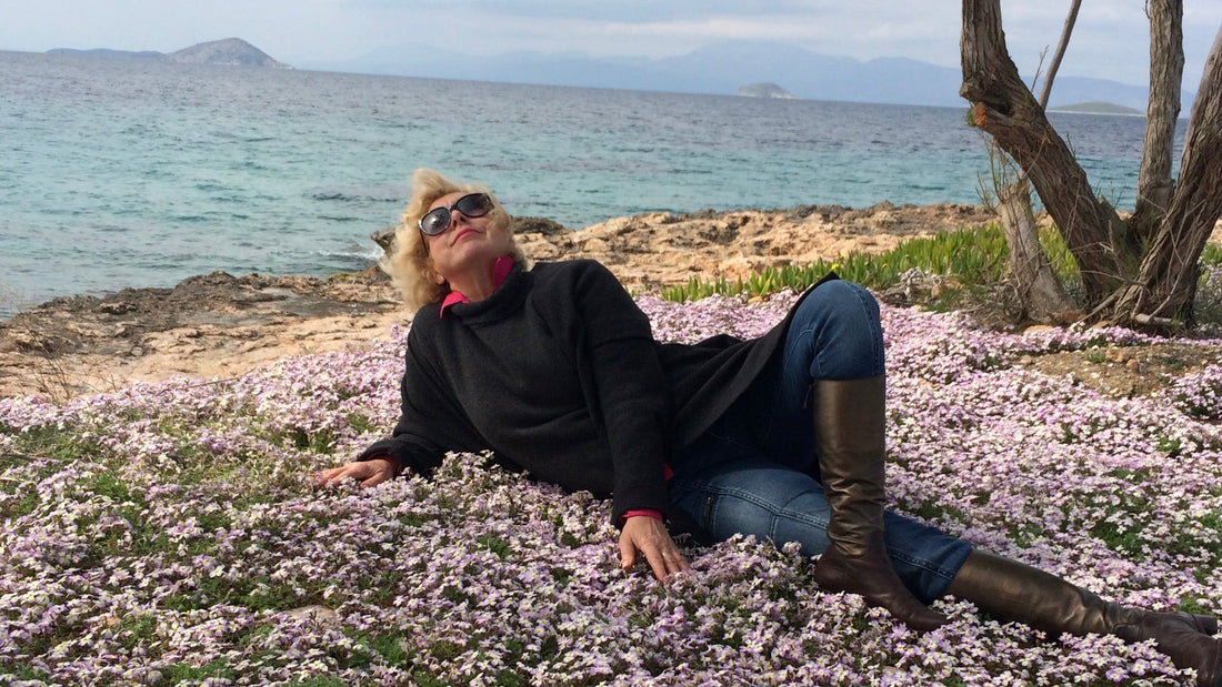 Lying in wild spring violets by the sea on Aegina Island Greece — Mediterranean longevity lifestyle
